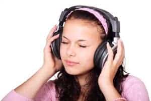 Girl with headphones listening to a subliminal to help manifest a husband