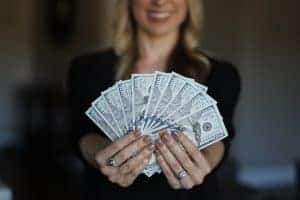 Beginner manifestation tips for money this woman holding money learned
